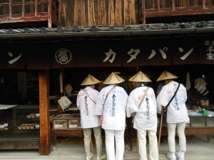Some ohenro buying gingersnap-like cookies at a traditional shop near Zentsuji, temple 75. 